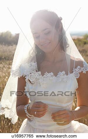 Newlywed bride standing outdoors View Large Photo Image Stock Photography - Newlywed bride standing outdoors. Fotosearch