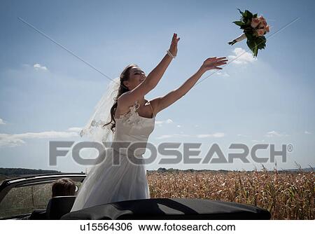 Newlywed bride tossing bouquet from car View Large Photo Image Stock Photograph - Newlywed bride tossing bouquet from car. Fotosearch