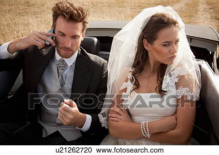 Stock Image - Newlywed couple arguing in car. Fotosearch