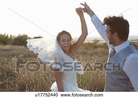 Newlywed couple dancing outdoors View Large Photo Image Stock Image - Newlywed couple dancing outdoors. Fotosearch