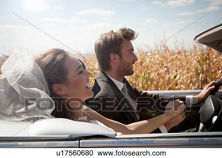 Newlywed couple driving in convertible View Large Photo Image Stock Image - Newlywed couple driving in convertible. Fotosearch