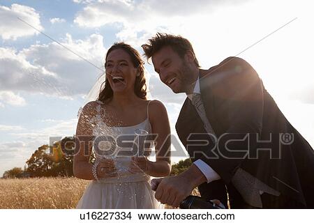 Newlywed couple having champagne View Large Photo Image Picture - Newlywed couple having champagne. Fotosearch