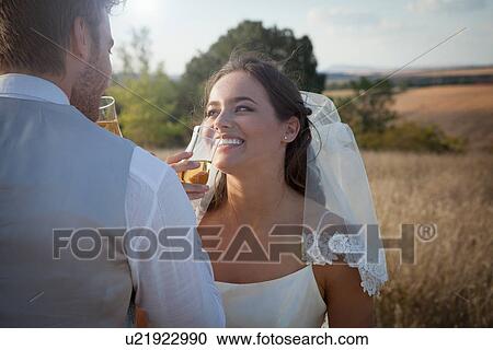 Newlywed couple having champagne View Large Photo Image Stock Image - Newlywed couple having champagne. Fotosearch