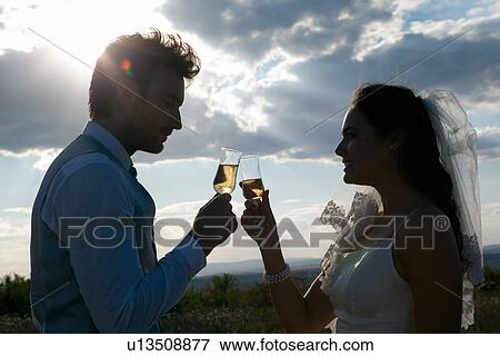 Newlywed couple having champagne View Large Photo Image Stock Photo - Newlywed couple having champagne. Fotosearch