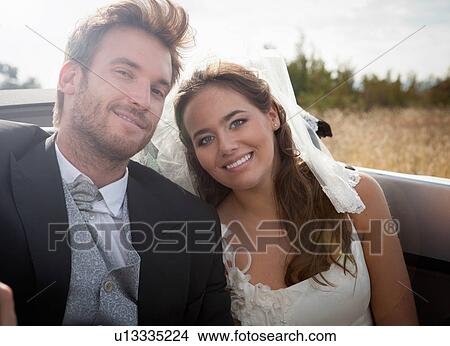 Newlywed couple sitting in convertible View Large Photo Image Picture - Newlywed couple sitting in convertible. Fotosearch