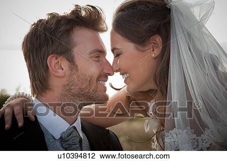 Newlywed couple touching noses View Large Photo Image Stock Image - Newlywed couple touching noses. Fotosearch