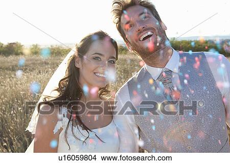 Newlywed couple walking in confetti View Large Photo Image Picture - Newlywed couple walking in confetti. Fotosearch