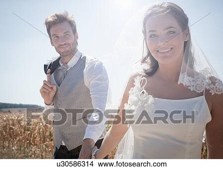 Newlywed couple walking outdoors View Large Photo Image Picture - Newlywed couple walking outdoors. Fotosearch