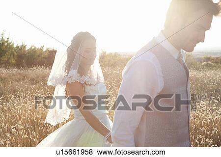 Newlywed couple walking outdoors View Large Photo Image Stock Photo - Newlywed couple walking outdoors. Fotosearch