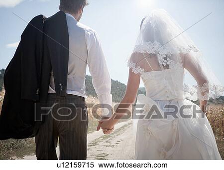 Stock Photography - Newlywed couple walking outdoors. Fotosearch