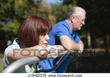 Older couple relaxing in park View Large Photo Image Stock Photo - Older couple relaxing in park. Fotosearch