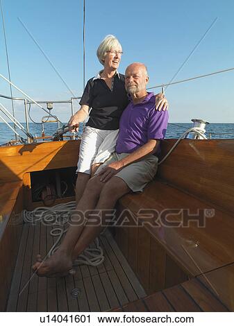 Older couple relaxing on sailboat View Large Photo Image Stock Image - Older couple relaxing on sailboat. Fotosearch