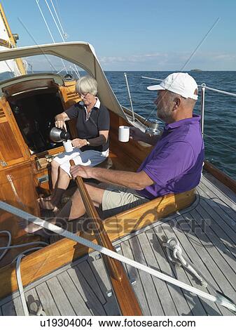 Older couple sailing together on ocean View Large Photo Image Picture - Older couple sailing together on ocean. Fotosearch