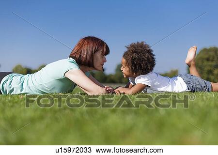 Stock Image - Older woman playing with granddaughter. Fotosearch
