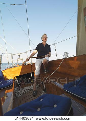 Older woman steering sailboat View Large Photo Image Picture - Older woman steering sailboat. Fotosearch