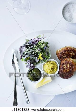 Plate of fish with herb salad View Large Photo Image Stock Photo - Plate of fish with herb salad. Fotosearch