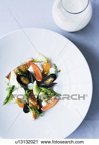 Stock Image - Plate of mussels with salad. Fotosearch