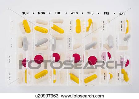 Stock Image - Portions of pills in organizer. Fotosearch