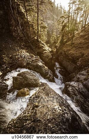 Stock Photo - River flowing in rocky landscape. Fotosearch