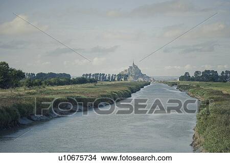 Picture - River running through rural landscape. Fotosearch