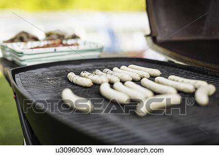 Sausages cooking on outdoor grill View Large Photo Image Stock Image - Sausages cooking on outdoor grill. Fotosearch