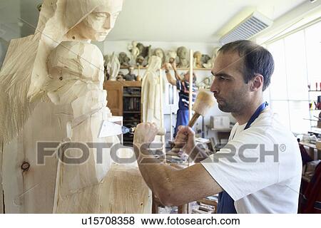 Sculptor chiseling figure from wood View Large Photo Image Stock Photo - Sculptor chiseling figure from wood. Fotosearch