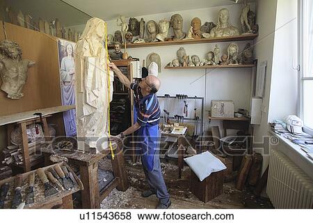 Sculptor measuring wooden figure View Large Photo Image Stock Photo - Sculptor measuring wooden figure. Fotosearch