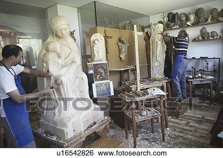 Sculptors chiseling figures from wood View Large Photo Image Stock Photograph - Sculptors chiseling figures from wood. Fotosearch