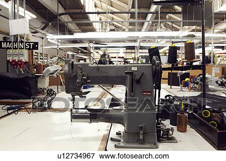 Sewing machine in clothing factory View Large Photo Image Stock Photo - Sewing machine in clothing factory. Fotosearch