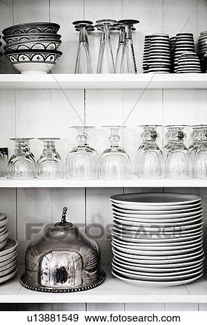 Shelves with glasses, plates and bowls View Large Photo Image Stock Photo - Shelves with glasses, plates and bowls. Fotosearch
