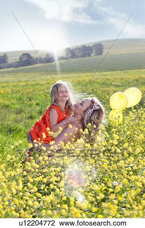 Sisters playing in field of flowers View Large Photo Image Stock Image - Sisters playing in field of flowers. Fotosearch
