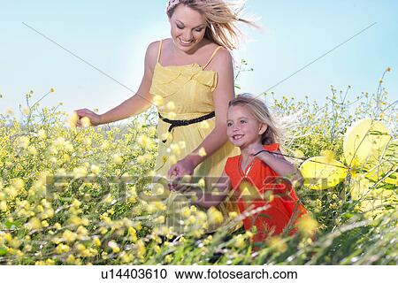Sisters playing in field of flowers View Large Photo Image Stock Image - Sisters playing in field of flowers. Fotosearch