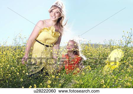 Sisters playing in field of flowers View Large Photo Image Stock Image - Sisters playing in field of flowers. Fotosearch