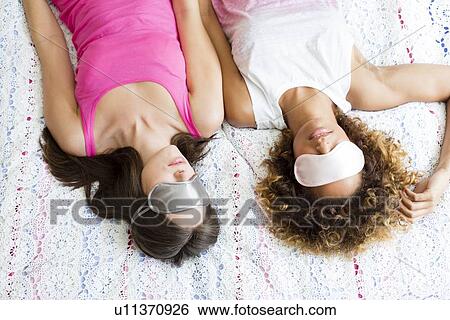 Sleeping woman wearing face masks View Large Photo Image Stock Photograph - Sleeping woman wearing face masks. Fotosearch