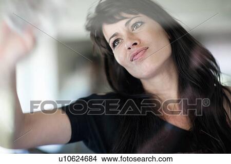 Smiling businesswoman wiping window View Large Photo Image Picture - Smiling businesswoman wiping window. Fotosearch