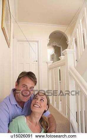 Smiling couple hugging on steps View Large Photo Image Stock Image - Smiling couple hugging on steps. Fotosearch