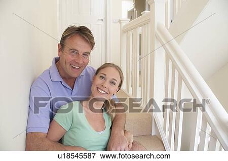 Smiling couple hugging on steps View Large Photo Image Stock Photo - Smiling couple hugging on steps. Fotosearch