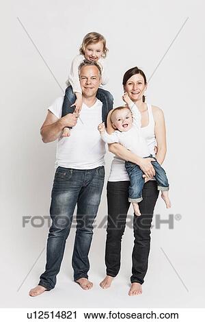 Smiling family posing together View Large Photo Image Stock Image - Smiling family posing together. Fotosearch
