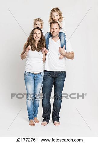 Stock Image - Smiling family posing together. Fotosearch