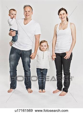 Smiling family posing together View Large Photo Image Stock Photo - Smiling family posing together. Fotosearch