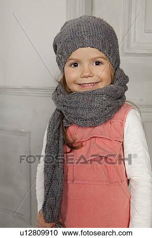 Smiling girl wearing hat and scarf View Large Photo Image Stock Image - Smiling girl wearing hat and scarf. Fotosearch