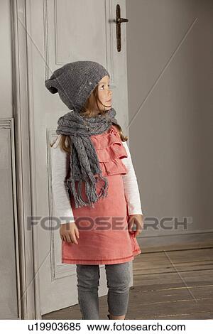 Stock Photography - Smiling girl wearing hat and scarf. Fotosearch