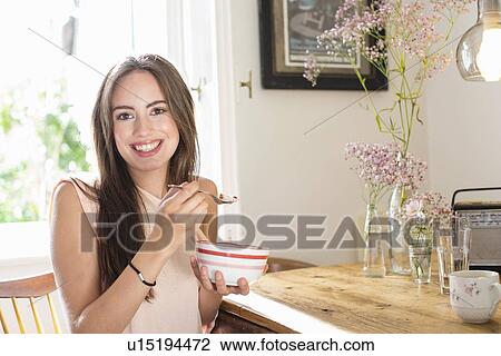 Smiling woman eating breakfast View Large Photo Image Stock Image - Smiling woman eating breakfast. Fotosearch