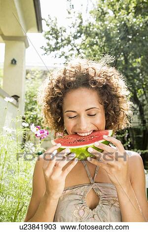 Smiling woman eating watermelon View Large Photo Image Stock Image - Smiling woman eating watermelon. Fotosearch