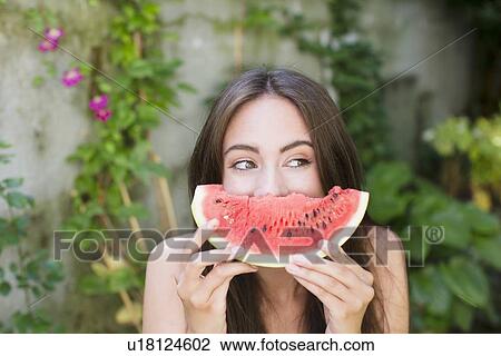 Smiling woman playing with watermelon View Large Photo Image Stock Image - Smiling woman playing with watermelon. Fotosearch