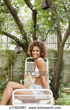 Smiling woman sunbathing outdoors View Large Photo Image Stock Image - Smiling woman sunbathing outdoors. Fotosearch