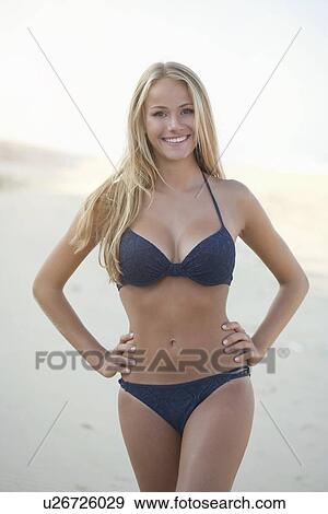 Smiling woman wearing bikini on beach View Large Photo Image Stock Photo - Smiling woman wearing bikini on beach. Fotosearch