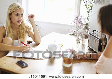 Smiling women having cup of coffee View Large Photo Image Stock Image - Smiling women having cup of coffee. Fotosearch