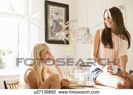 Smiling women having cup of coffee View Large Photo Image Stock Image - Smiling women having cup of coffee. Fotosearch
