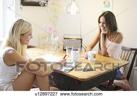 Smiling women having cup of coffee View Large Photo Image Stock Photo - Smiling women having cup of coffee. Fotosearch